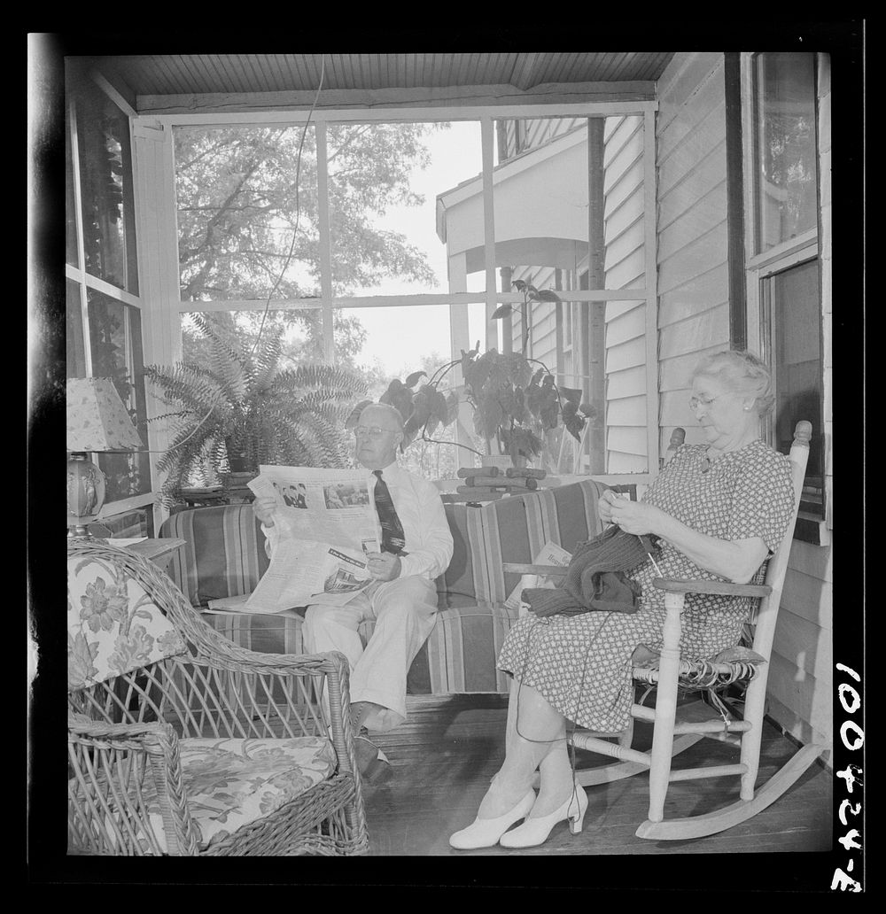 Mechanicsville, Maryland. Mr. and Mrs. Charles Herbert sitting on the porch of the home which he helped to build when he…