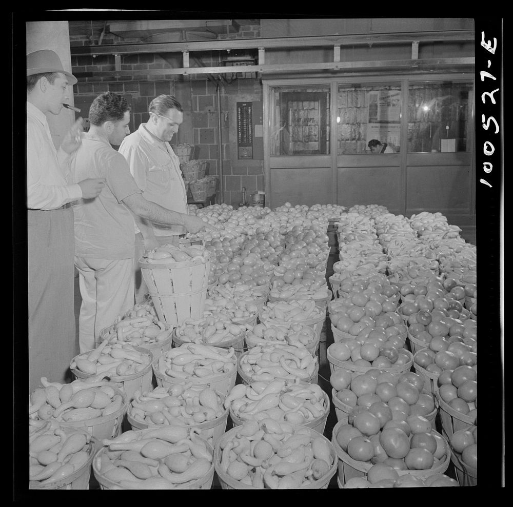 Washington, D.C. Assistant foreman of produce department at the District grocery store warehouse checking over a load of…