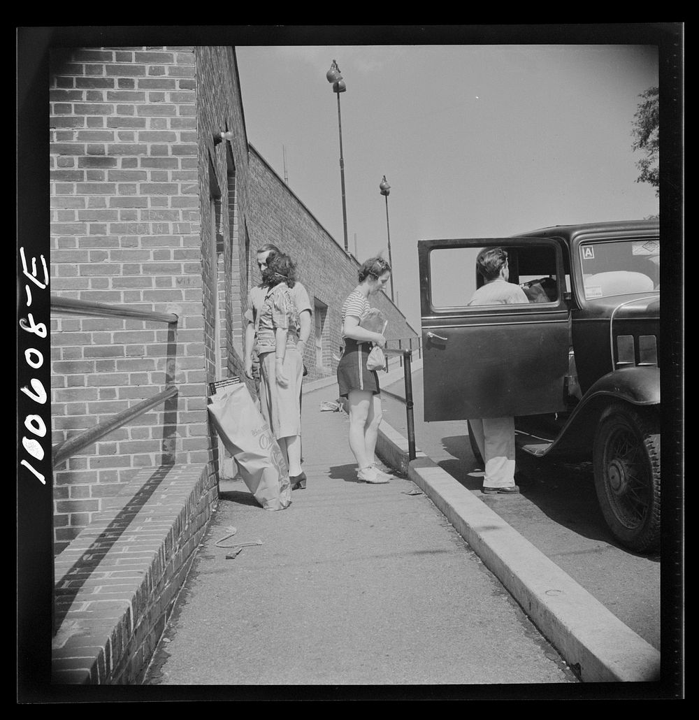 Washington, D.C. Loading groceries into a car at the Giant Food shopping center on Wisconsin Avenue. Sourced from the…