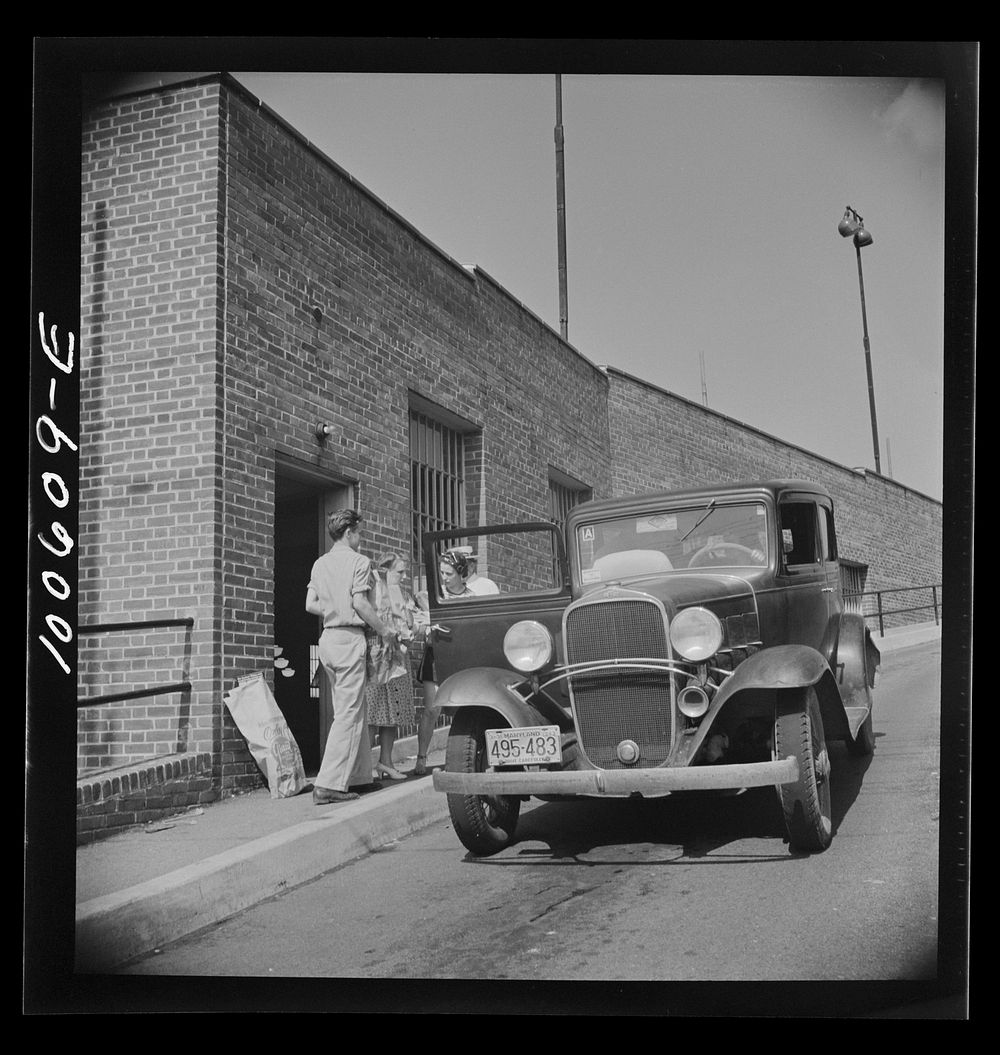 [Untitled photo, possibly related to: Washington, D.C. Loading groceries into a car at the Giant Food shopping center on…
