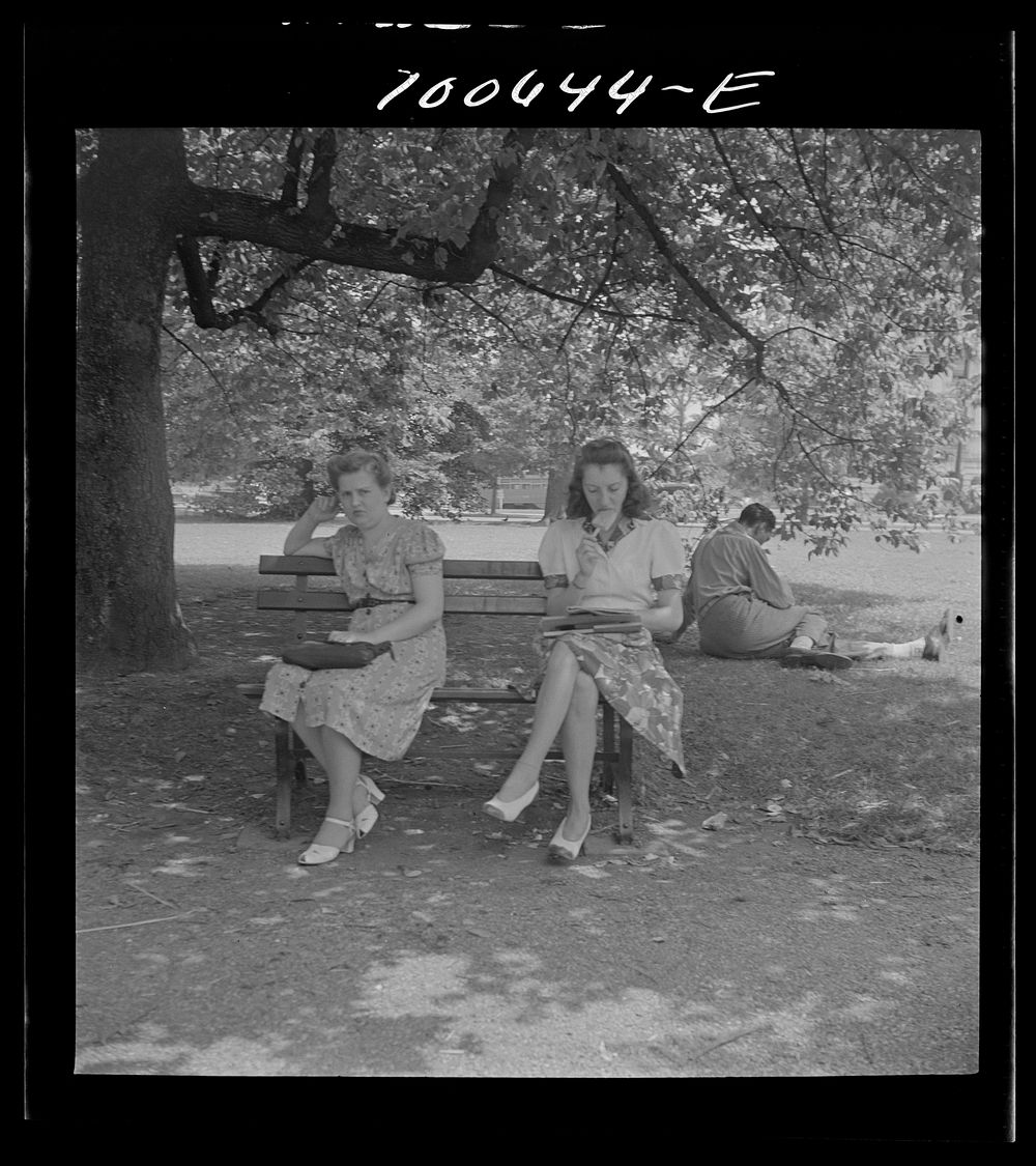 Washington, D.C. Government workers lunching and resting in Washington Monument park outside the U.S. Department of…