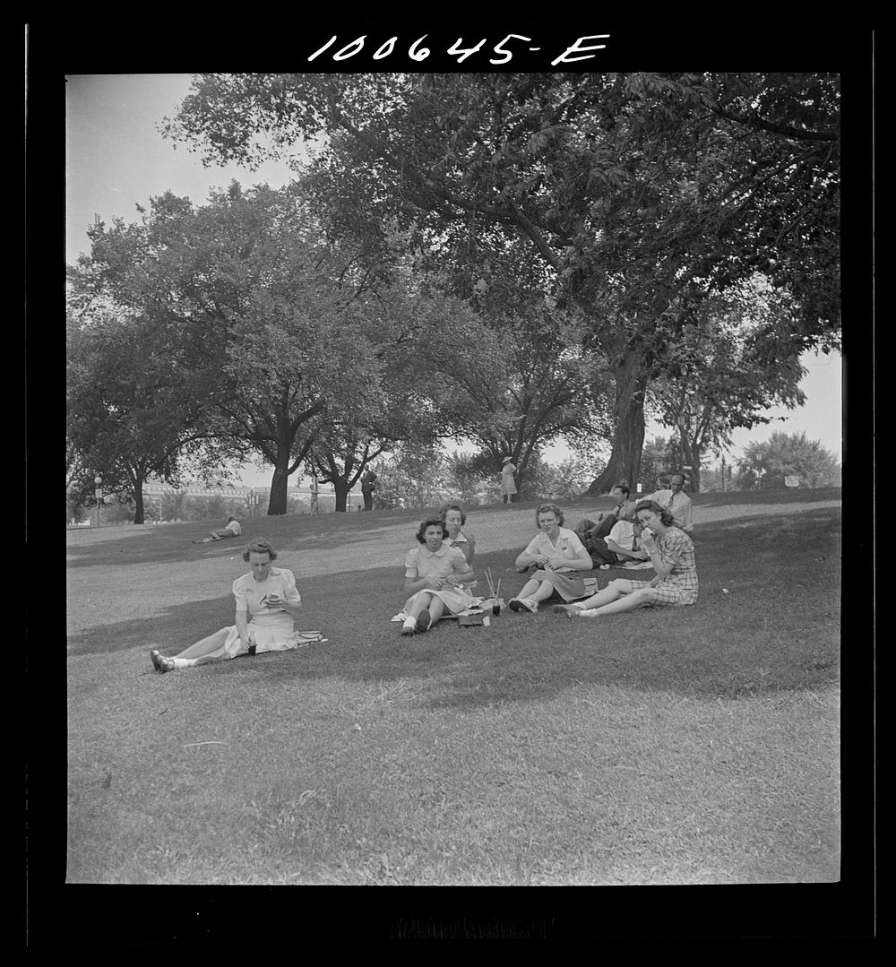 Washington, D.C. Government workers lunching and resting in Washington Monument park outside the U.S. Department of…