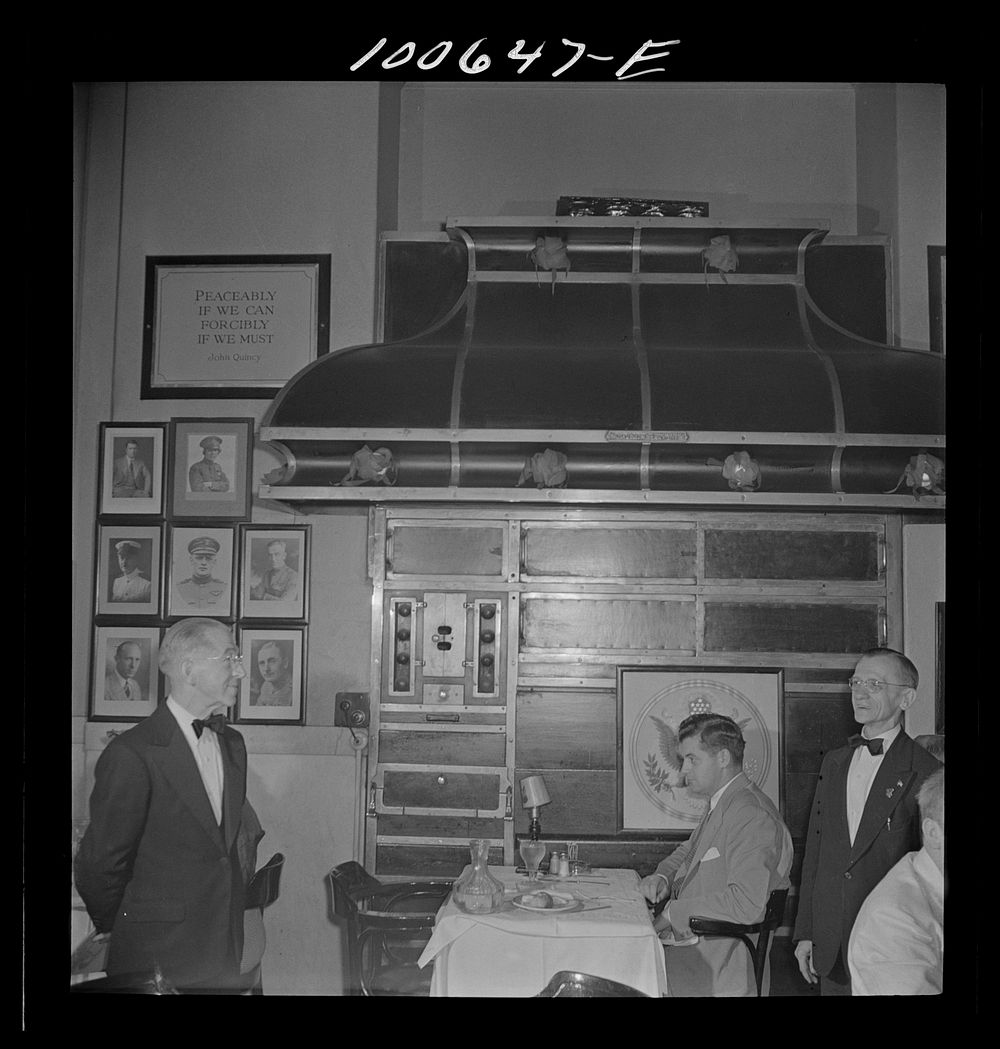 Washington, D.C. Head waiter, waiter, and diner at the Occidental Hotel restaurant. An old stove is used as decoration.…