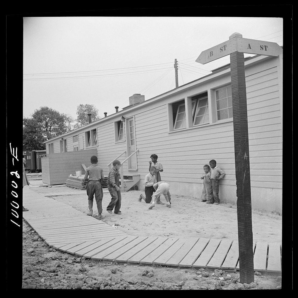 Arlington, Virginia. FSA (Farm Security Administration) trailer camp project for es. Children playing marbles outside the…