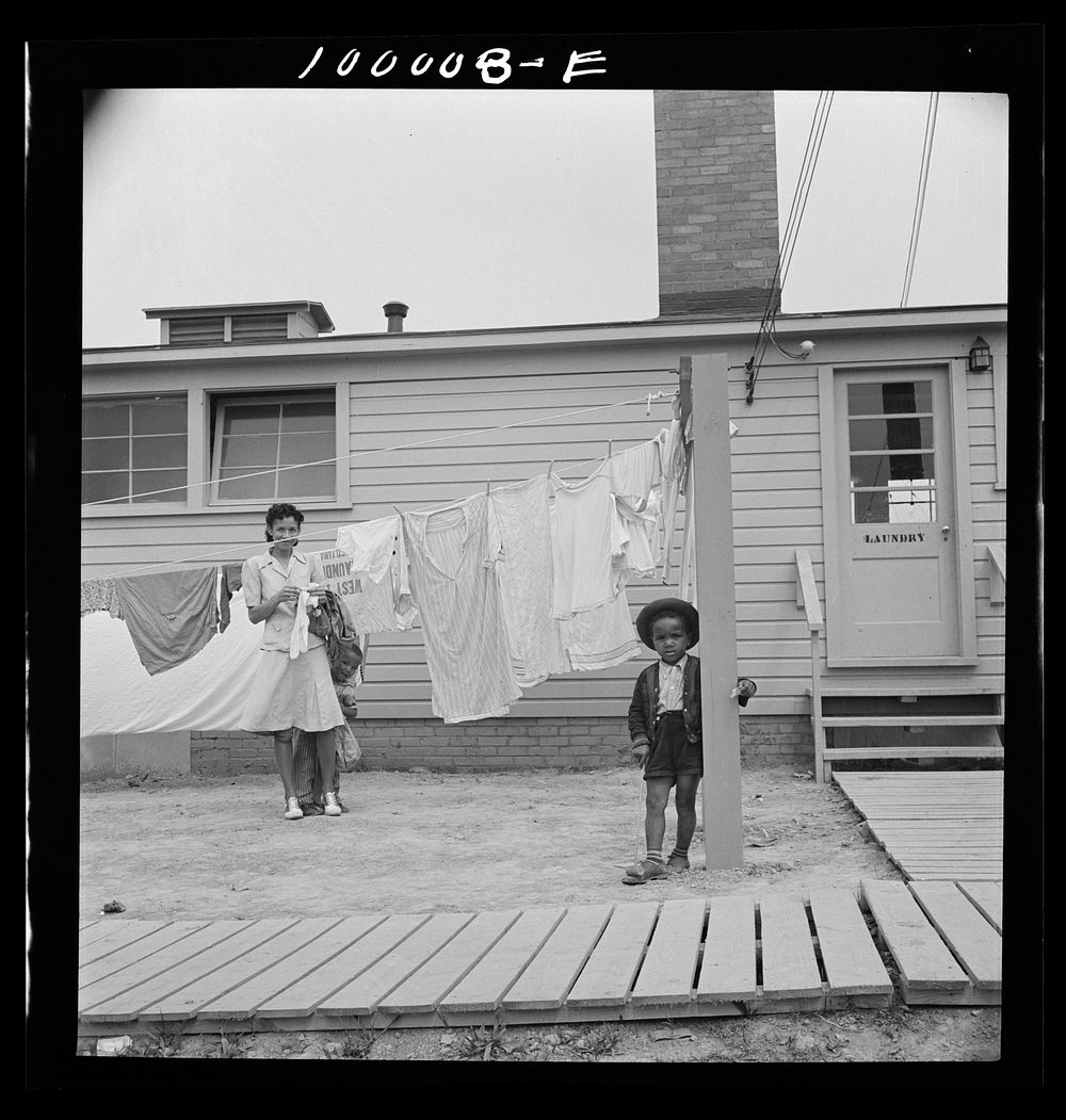 Arlington, Virginia. FSA (Farm Security Administration) trailer camp project for es. Hanging out clothes which have been…
