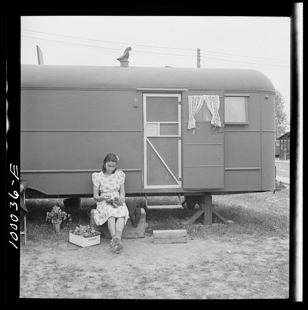 Arlington, Virginia. FSA (Farm Security Administration) trailer camp project for es. Girl occupant preparing vegetables…