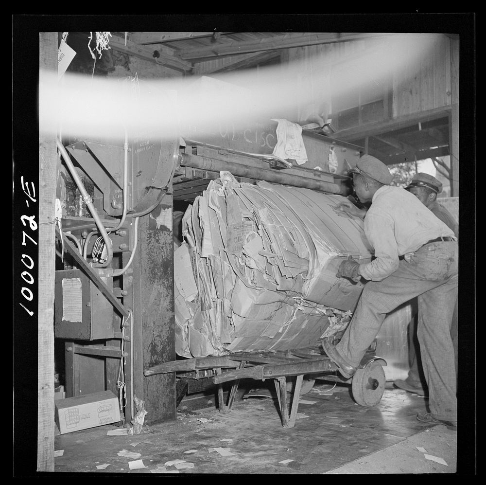 Washington, D.C. Salvage drive, Victory Program. Bales of pressed scrap paper being unloaded from hydraulic press in…