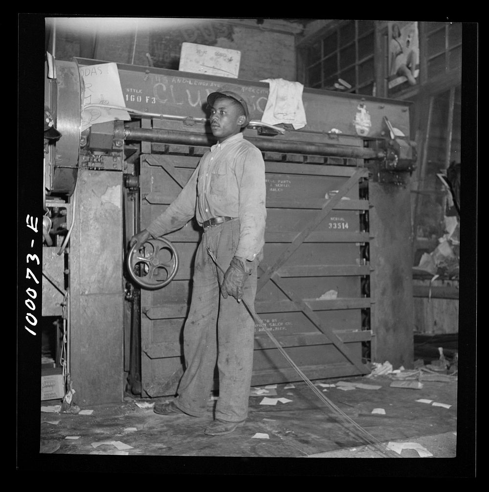 Washington, D.C. Salvage drive, Victory Program. Hydraulic press for scrap paper in retail junk company. Sourced from the…