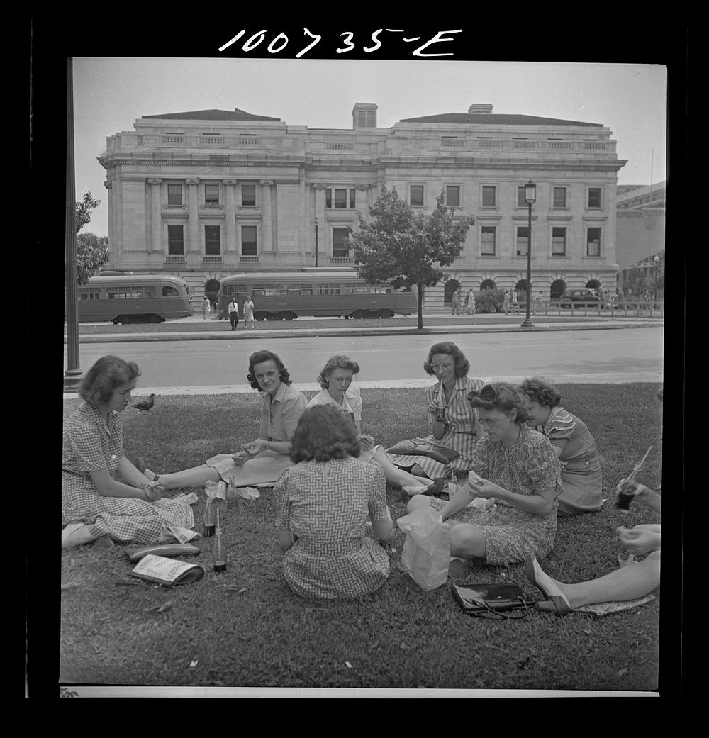 Washington, D.C. Government workers lunch outside the U.S. Department of Agriculture in Washington Monument park. Sourced…