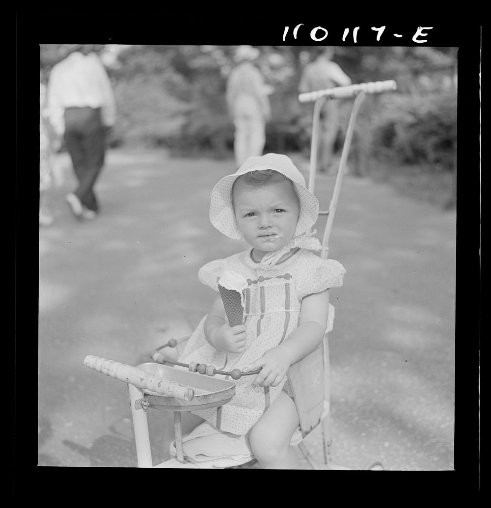 Detroit, Michigan. Little girl with ice cream cone in the zoological park. Sourced from the Library of Congress.