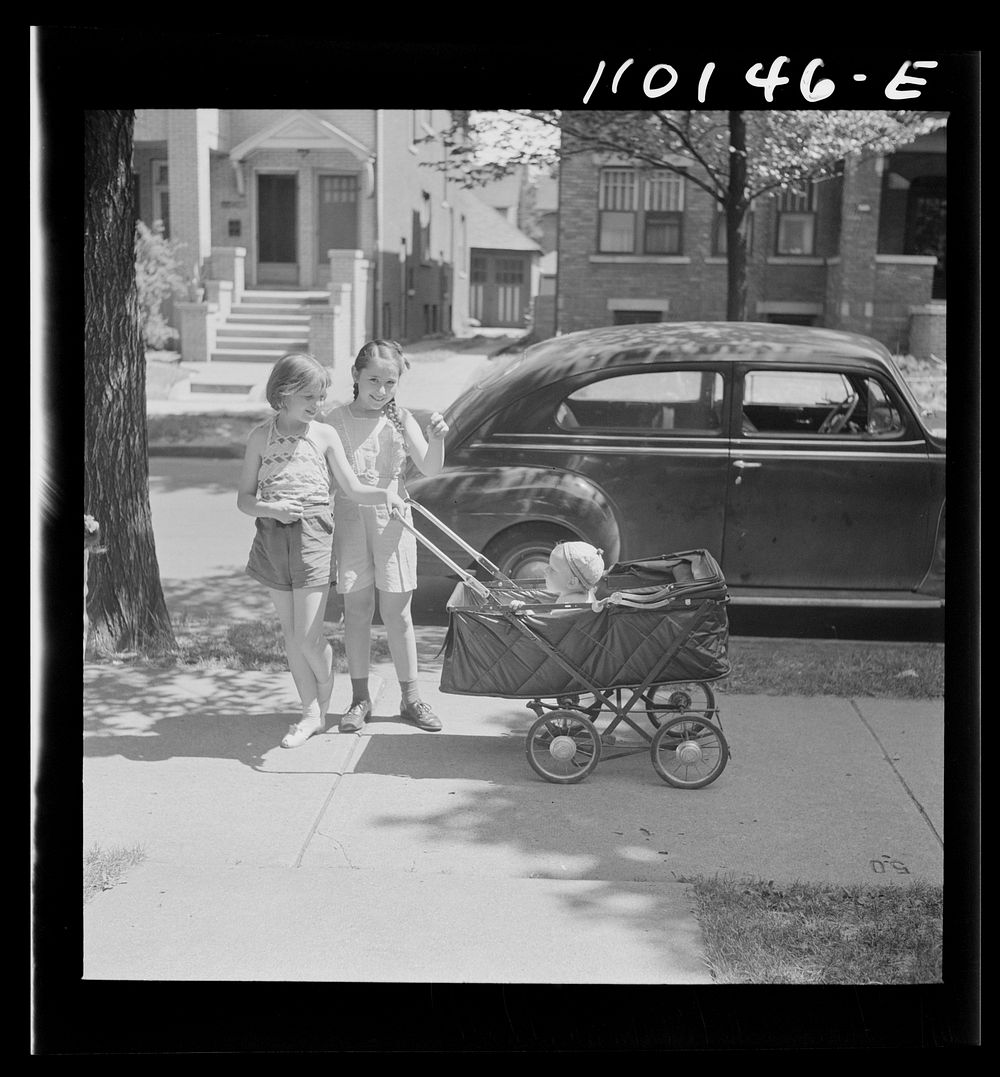 Detroit, Michigan. Little girls wheeling baby brother in a carriage. Sourced from the Library of Congress.
