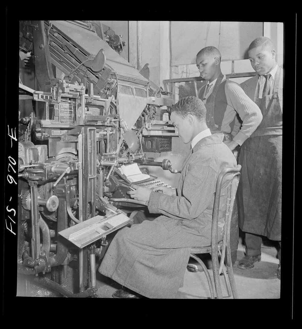 Washington, D.C. Setting type for the school paper on a lithograph machine at the Armstrong Technical High School. Sourced…
