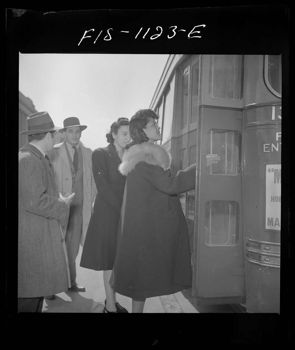 Washington, D.C. Jewal Mazique [i.e. Jewel], worker at the Library of Congress, buying a paper on her way home. Sourced from…