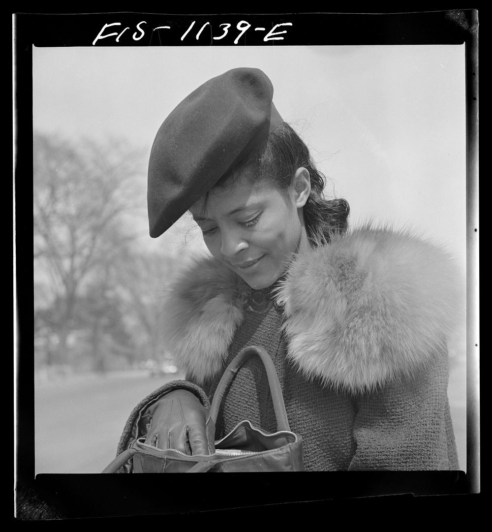Washington, D.C. Jewal Mazique [i.e. Jewel], worker at the Library of Congress, waiting for a streetcar on her way home from…