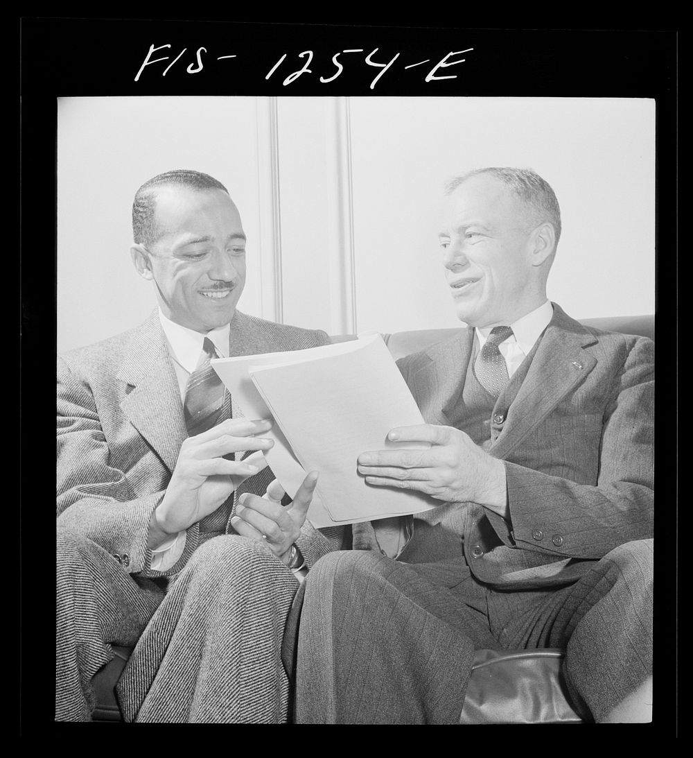 Washington, D.C. William H. Hastie, civilian aide to the Secretary of War, in conference with Undersecretary of War…