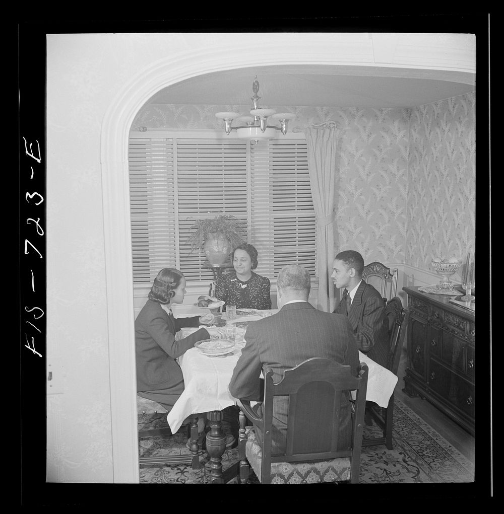 Washington, D.C.  family at dinner. The husband is a doctor, the wife a teacher, the son a student at Howard University, and…