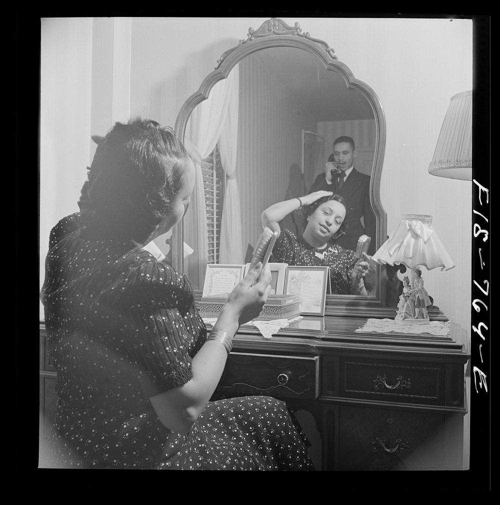 [Untitled photo, possibly related to: Washington, D.C. Teacher in a  grammar school in her bedroom at home. Her husband is a…