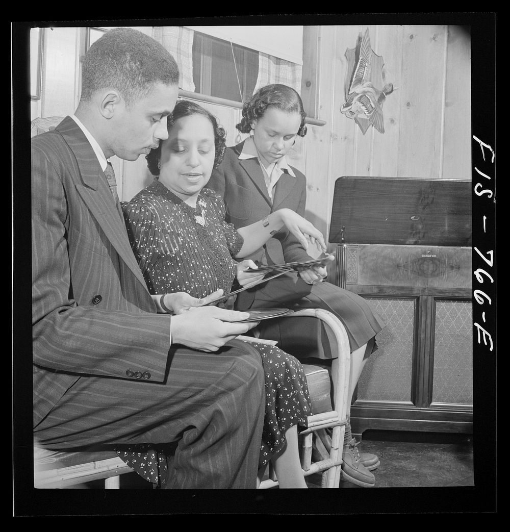 [Untitled photo, possibly related to: Washington, D.C.  school teacher whose husband is a doctor choosing records in the…