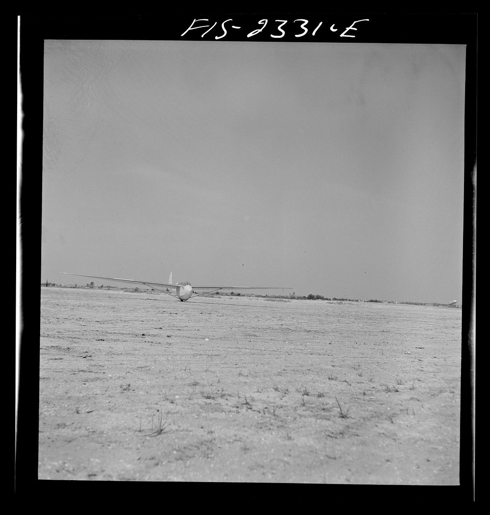 [Untitled photo, possibly related to: Parris Island, South Carolina. A glider plane being towed over a field at the U.S.…
