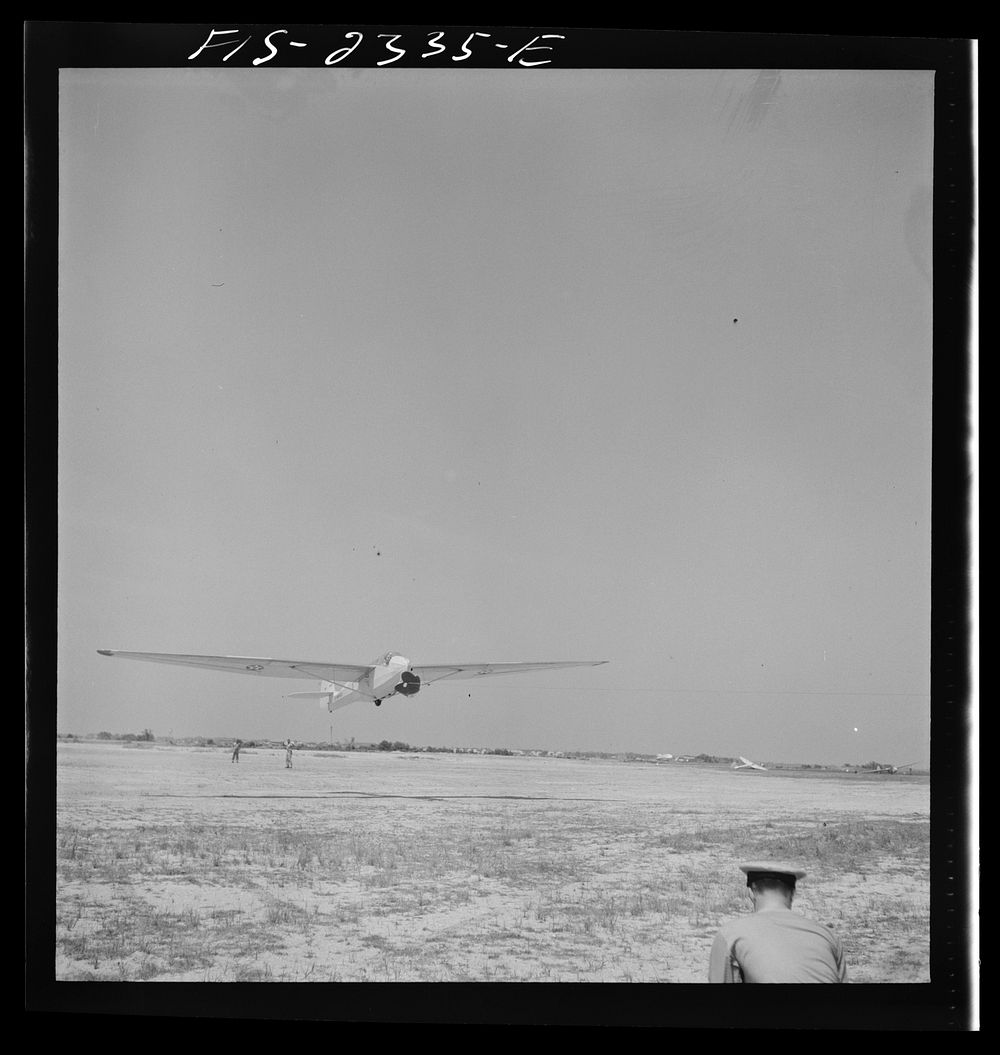 Parris Island, South Carolina. A glider plane being towed over a field at the U.S. Marine Corps glider detachment training…