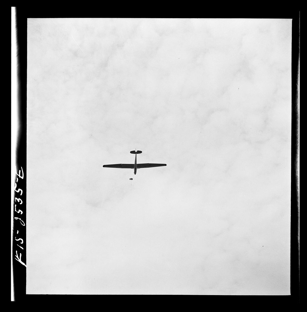 Parris Island, South Carolina. U.S. Marine Corps glider detachment training camp. Glider plane being towed through the sky.…