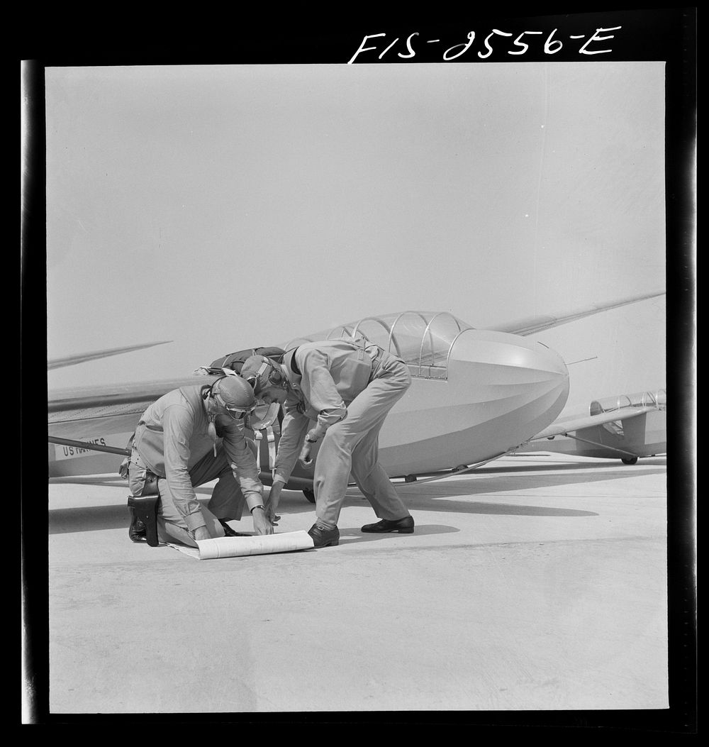 Parris Island, South Carolina.  Lieutenants of Marine Corps, studying glider pilotage, compare notes before a flight.…