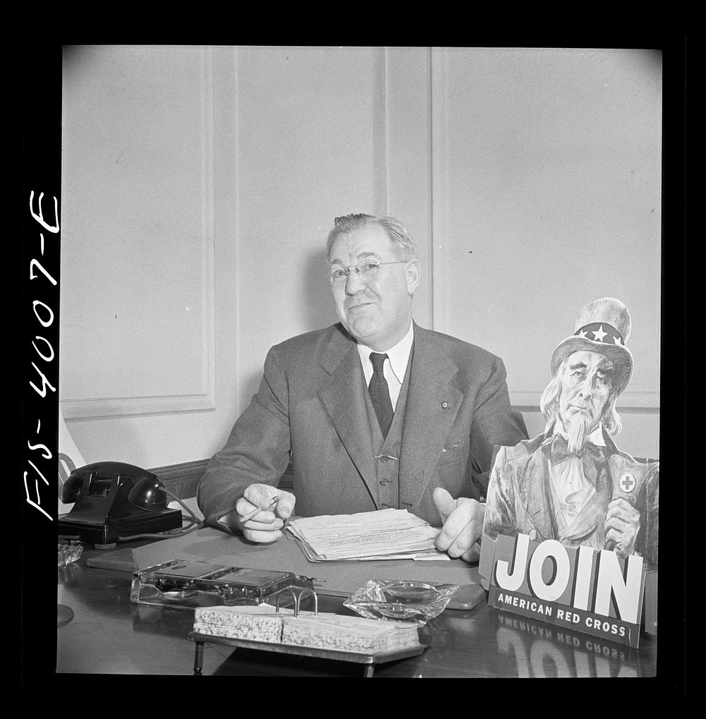 [Untitled photo, possibly related to: Washington, D.C. Mr. Lund, who is the head of the District Red Cross, at his desk in…
