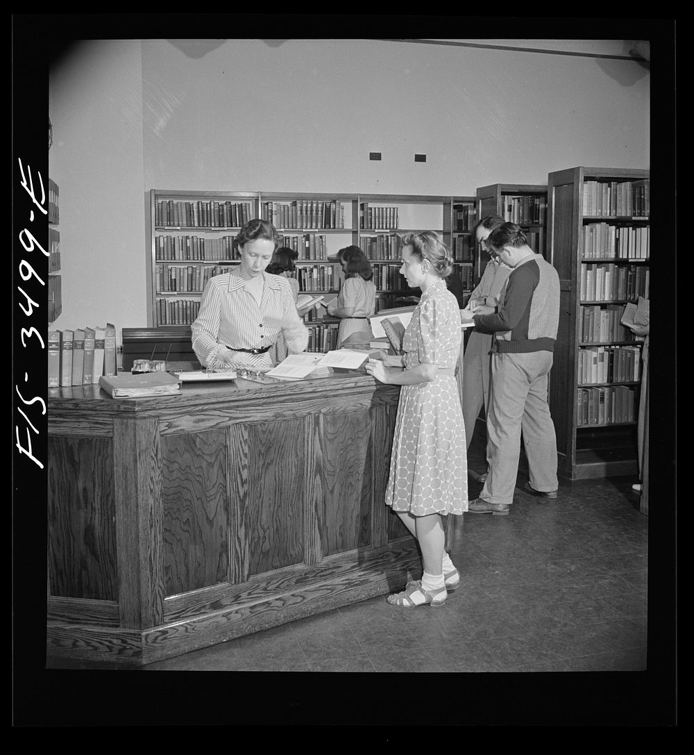 Greenbelt, Maryland. Federal housing project. The school library is used as a community library in the evening. Sourced from…