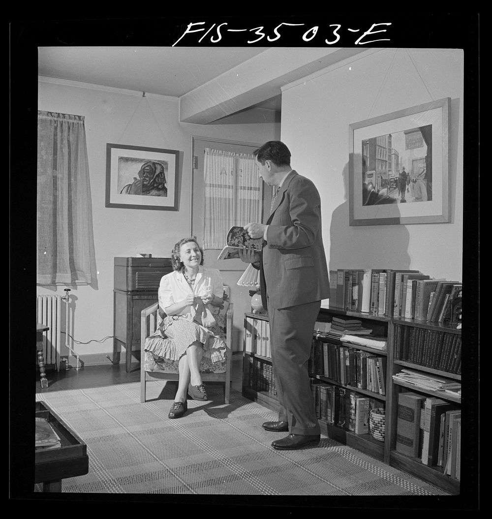 Greenbelt, Maryland. Federal housing project. Mr. and Mrs. Leslie Atkins in their living room discussing the seeds they plan…