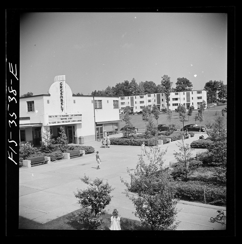 Greenbelt, Maryland. Federal housing project. View of the shopping center showing the moving picture house. Sourced from the…