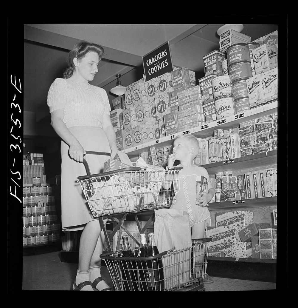 Greenbelt, Maryland. Federal housing project. Shopping in the cooperative grocery store. Sourced from the Library of…