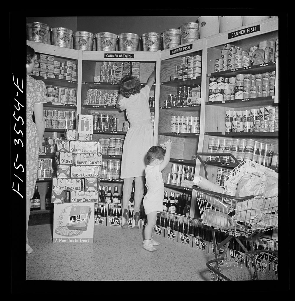 Greenbelt, Maryland. Federal housing project. Shopping in the cooperative grocery store. Sourced from the Library of…
