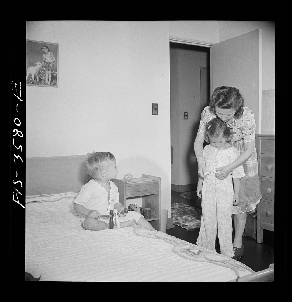 [Untitled photo, possibly related to: Greenbelt, Maryland. Mrs. Atkins putting Ann to bed in her room. Pierce has a room of…