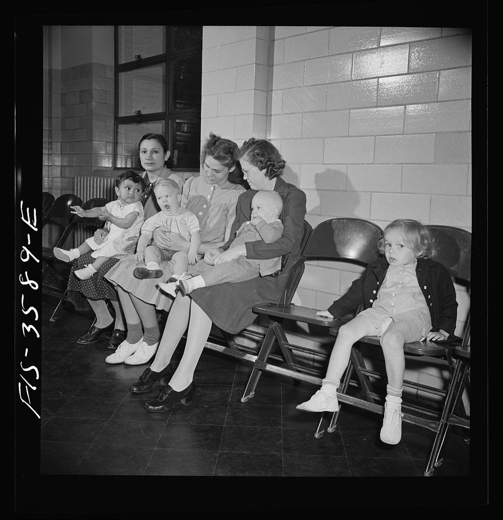 Greenbelt, Maryland. Mothers waiting with their children to get a physical examination by local doctors, offered free once a…