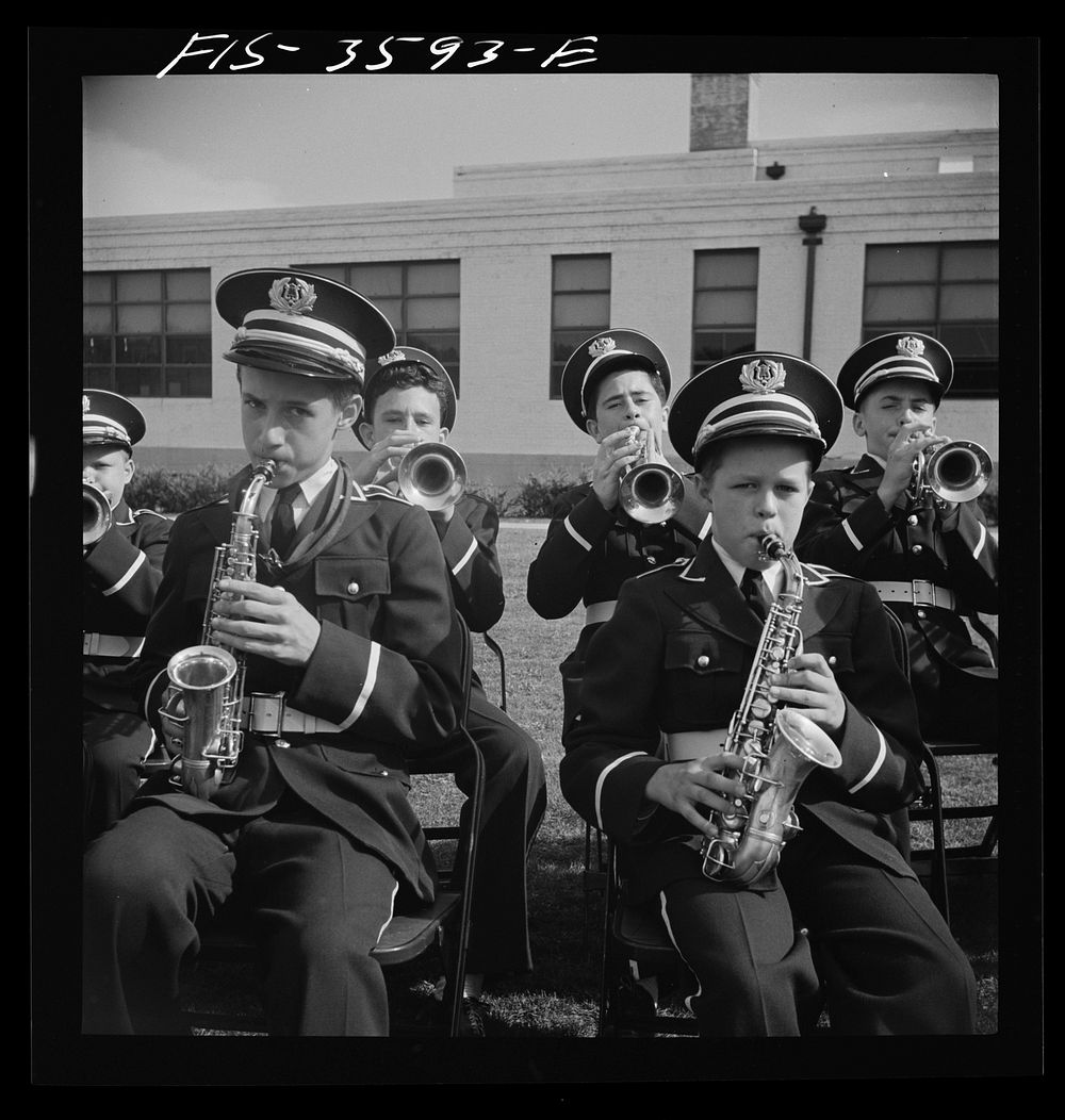 Greenbelt, Maryland. High school band in green uniforms giving a band concert on Memorial Day. Membership in the band is…