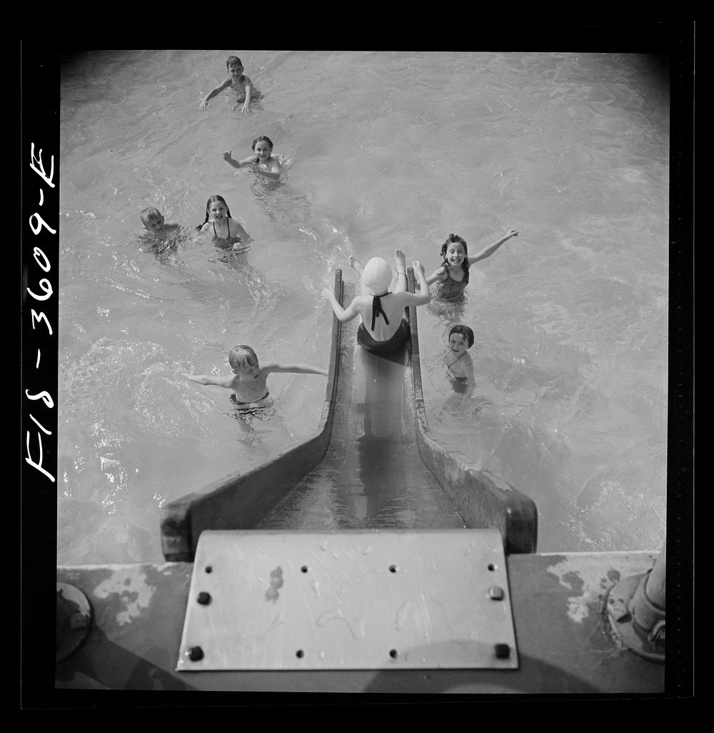 Greenbelt, Maryland. A constant stream of water runs down the swimming pool slide. Sourced from the Library of Congress.