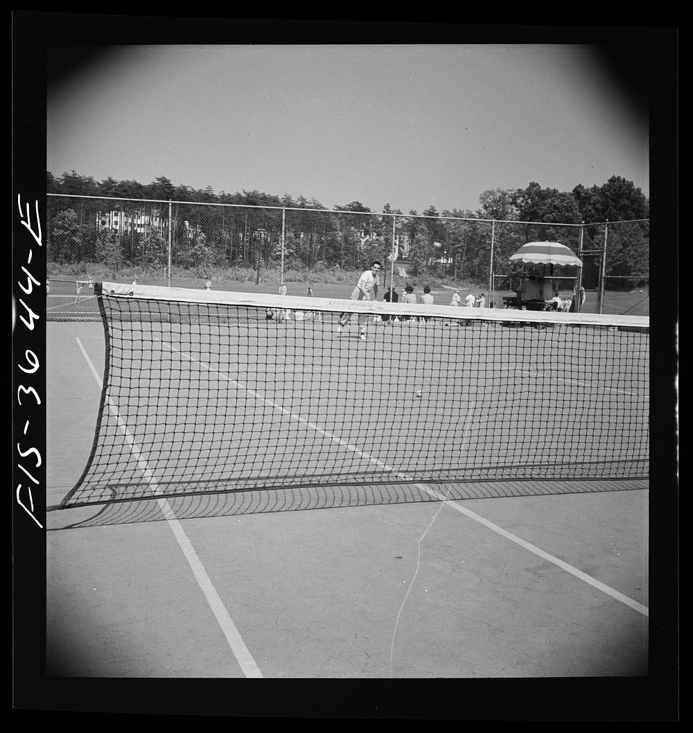 [Untitled photo, possibly related to: Greenbelt, Maryland. Tennis courts with the school in the background]. Sourced from…