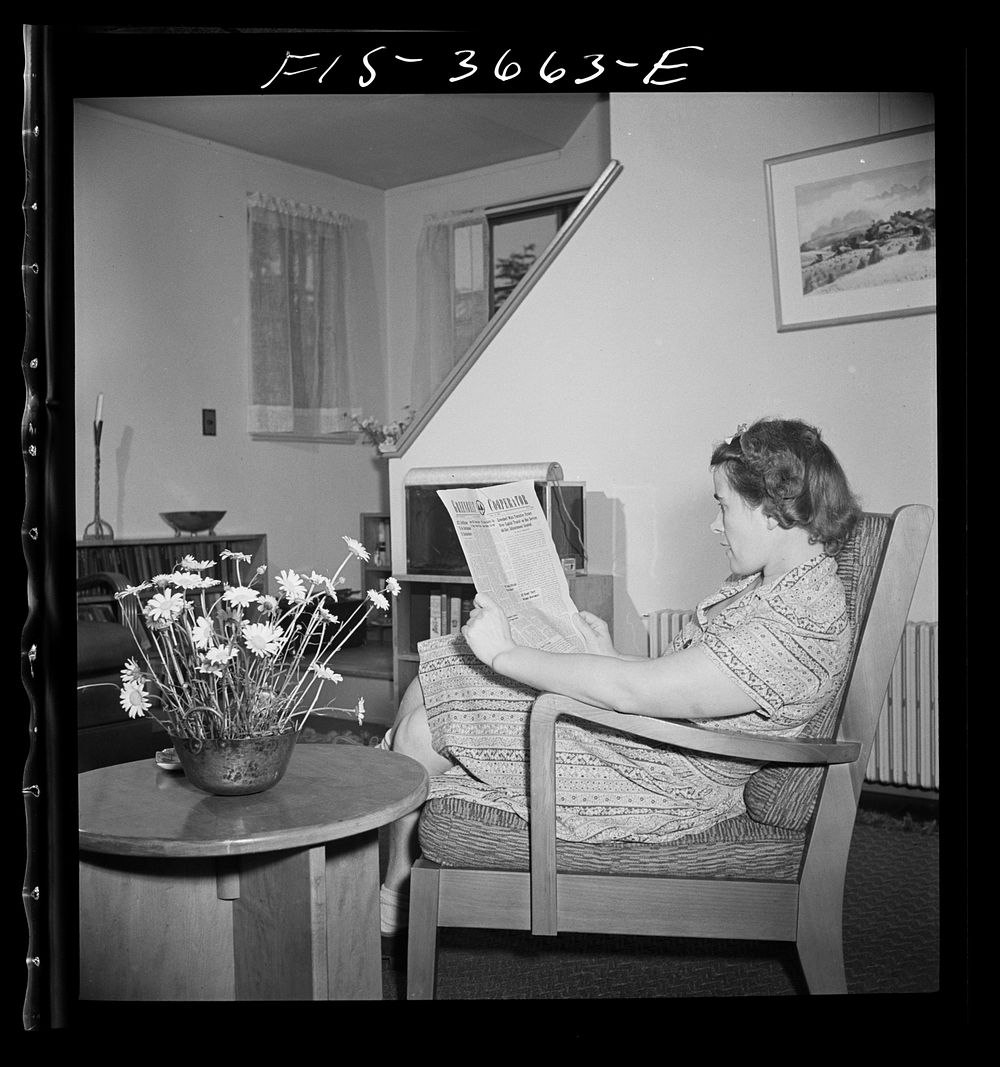 [Untitled photo, possibly related to: Greenbelt, Maryland. Mrs. Hoover reading a copy of the Greenbelt Cooperator. The chair…