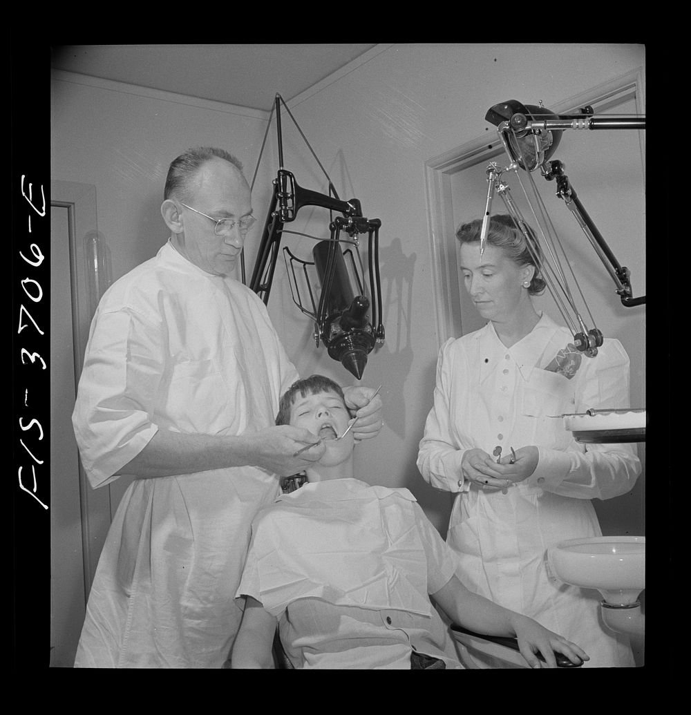 [Untitled photo, possibly related to: Greenbelt, Maryland. Dr. McCarl, Greenbelt dentist, treating a young patient]. Sourced…