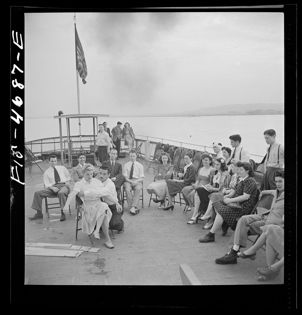 Washington, D.C. Bandaging an "injured" arm as part of a course in first aid, aboard a Potomac River boat. Sourced from the…