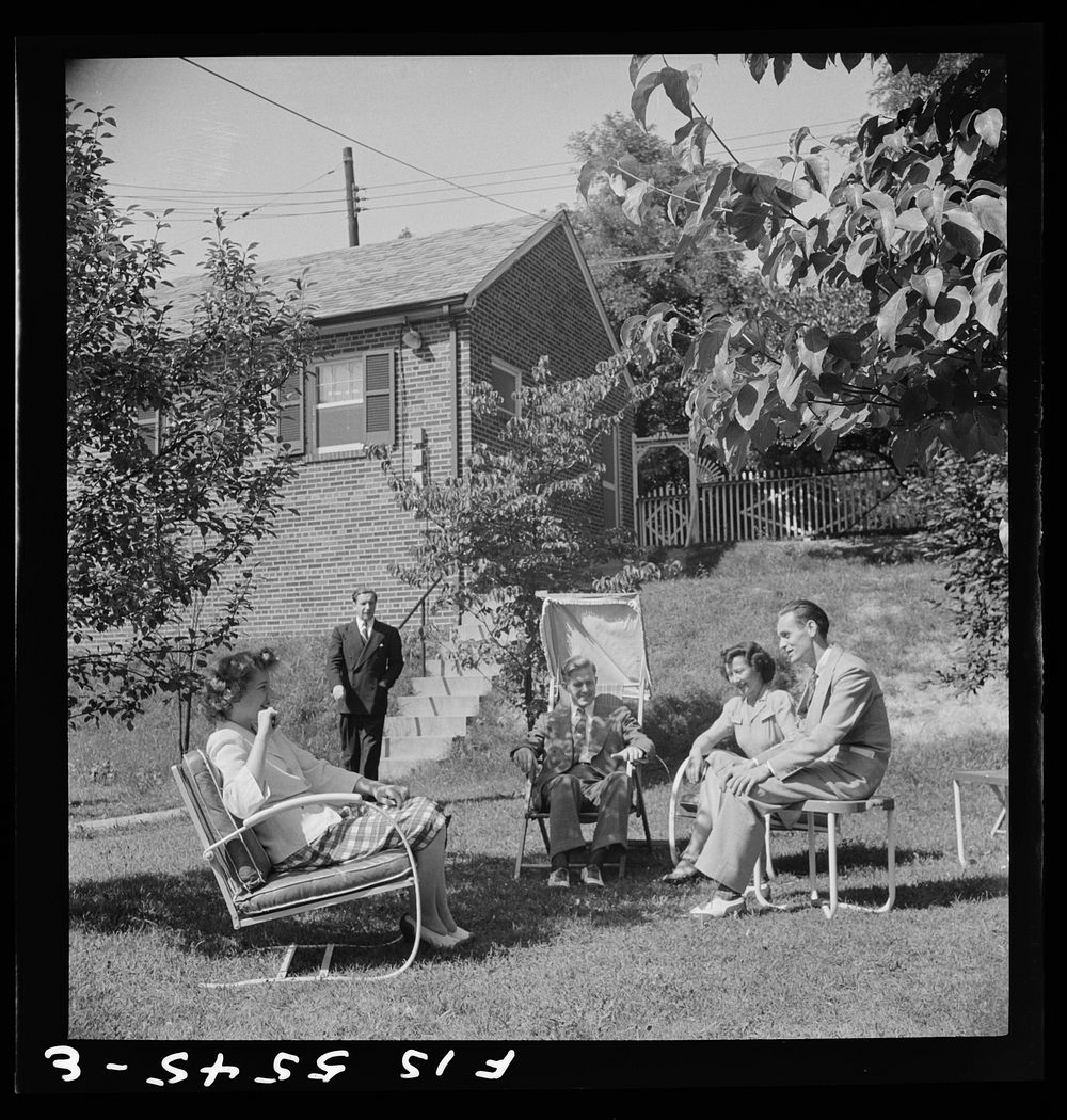 Washington, D.C. The Icelandic legation. Minister Thors joins his office staff in a brief respite on the lawn outside the…