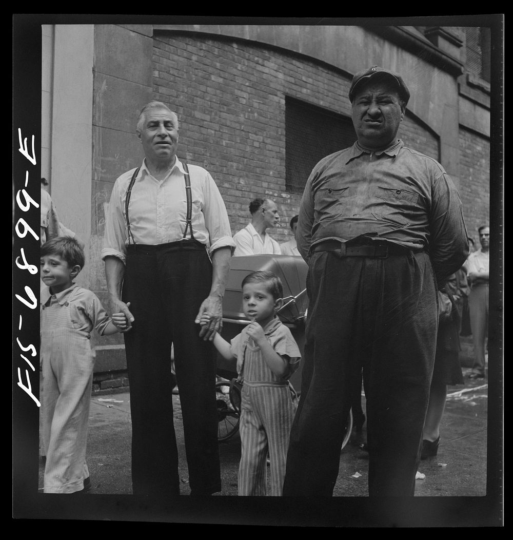 [Untitled photo, possibly related to: New York, New York. Italian-Americans in the rain watching a flag raising ceremony in…