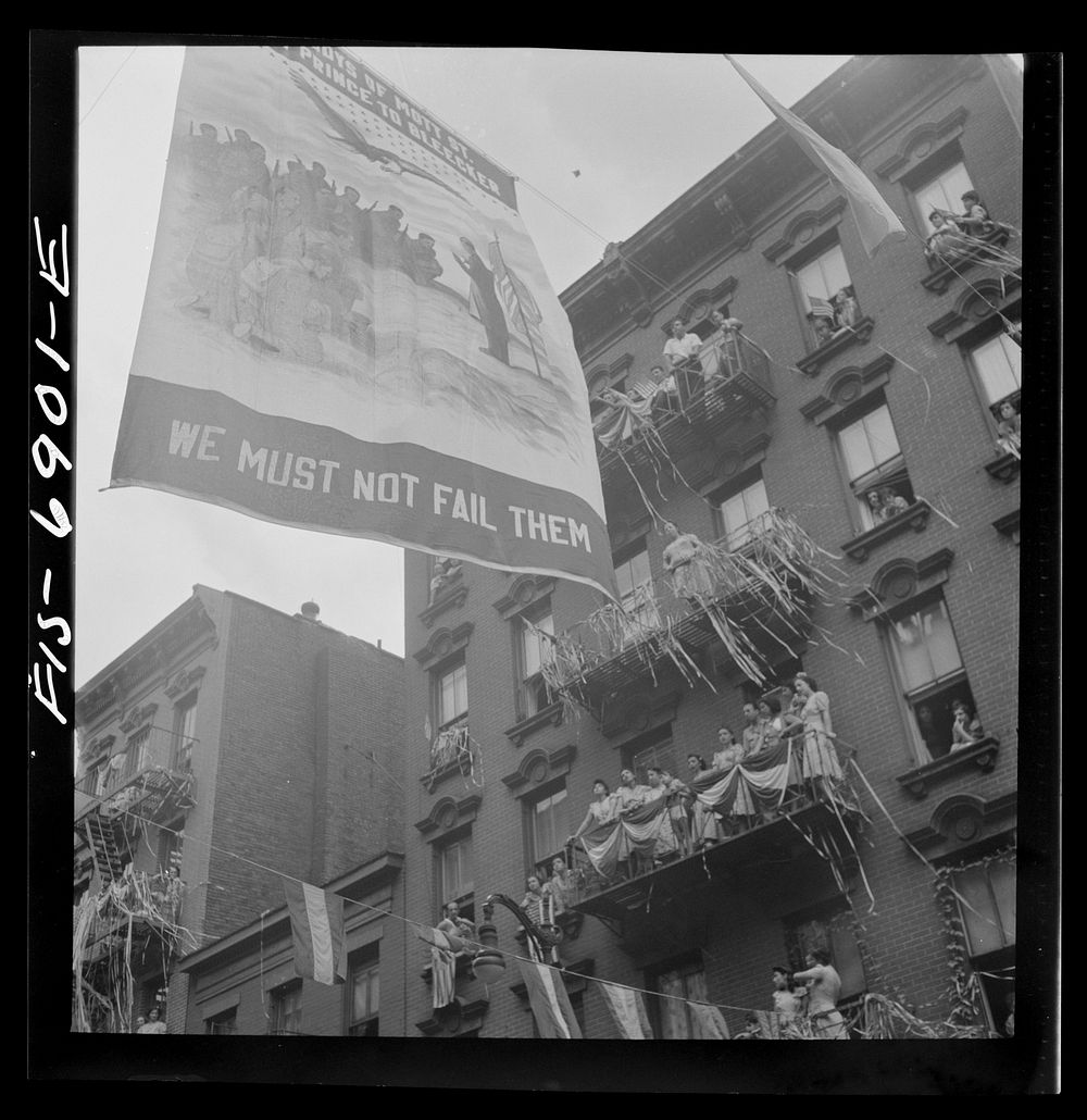 New York, New York. Flag raising ceremony in the rain in honor of Mott Street boys in the United States Army. Sourced from…