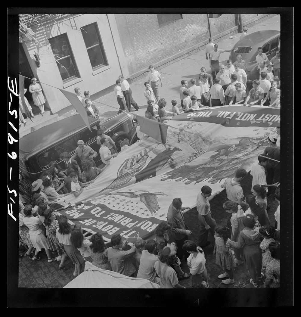 [Untitled photo, possibly related to: New York, New York. Italian-Americans of Mott Street raising a flag in honor of…