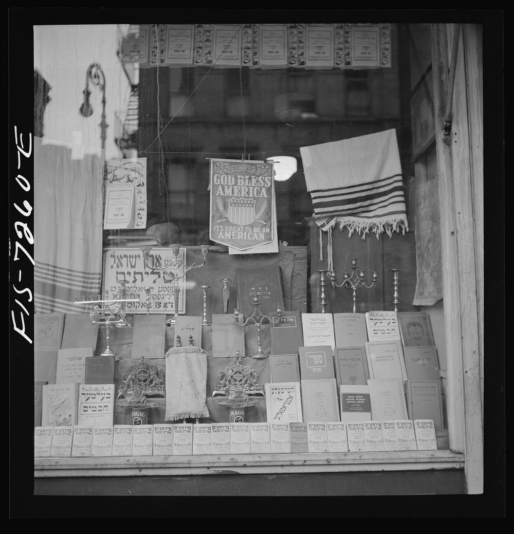 [Untitled photo, possibly related to: New York, New York. Window of a Jewish religious shop on Broom Street]. Sourced from…