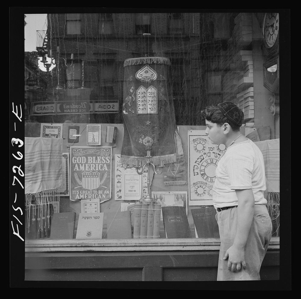 [Untitled photo, possibly related to: New York, New York. Window of a Jewish religious shop on Broom Street]. Sourced from…