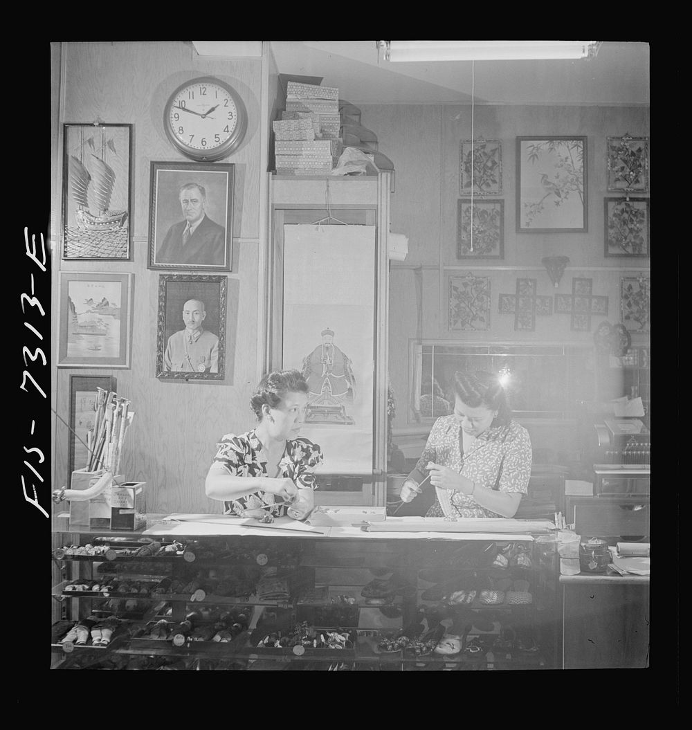 [Untitled photo, possibly related to: New York, New York. Lily Chi, owner of a Chinese gift shop in Chinatown, mending a…