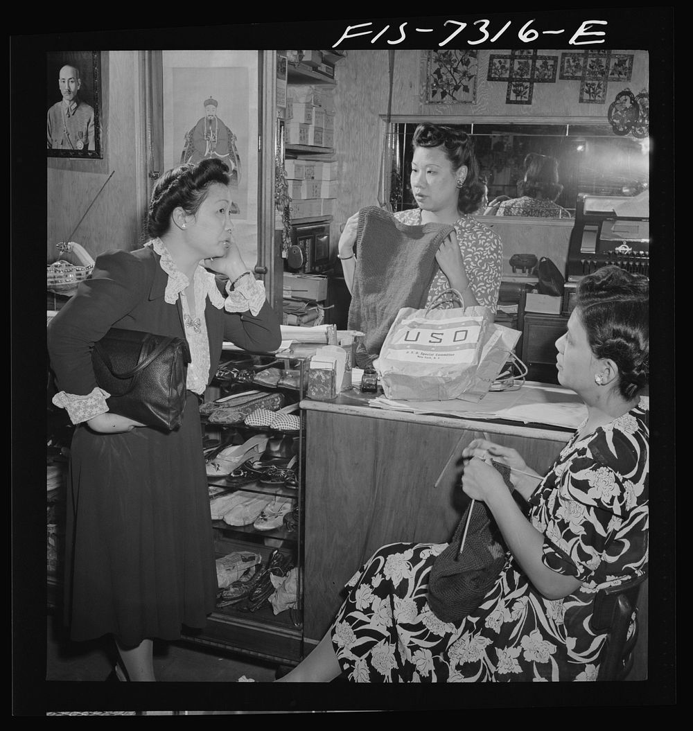[Untitled photo, possibly related to: New York, New York. Lily Chi, owner of a Chinese gift shop in Chinatown, mending a…
