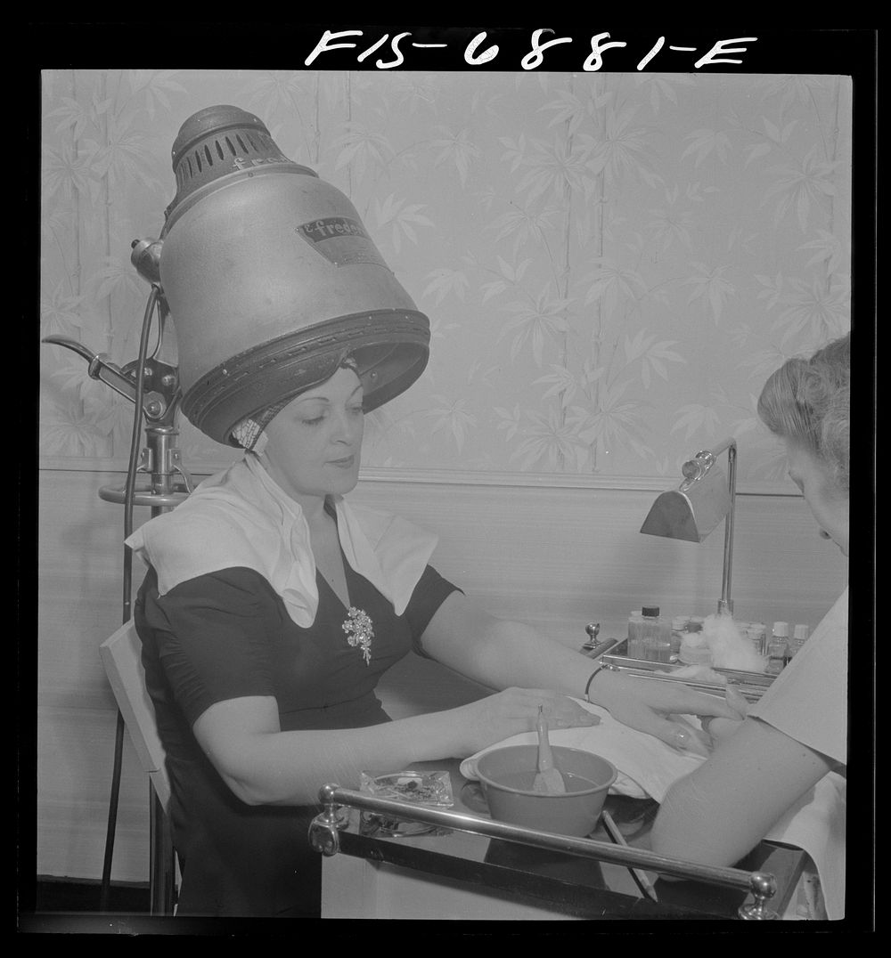 New York, New York. Getting a manicure while drying hair at Francois de Paris, a hairdresser on Eighth Street. Sourced from…