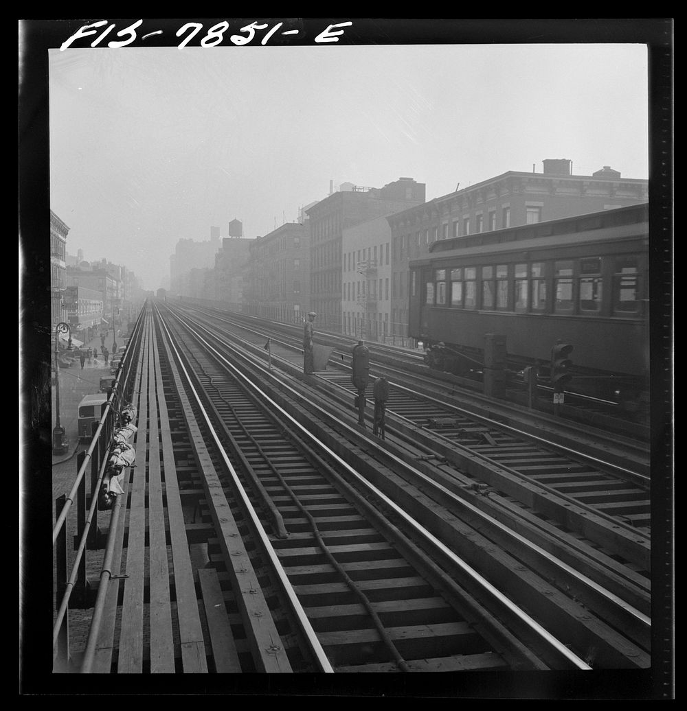 New York, New York. Signaller on the track of the Third Avenue elevated railway near 14th Street in the early morning.…